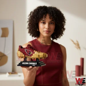 A woman holding a brick built football themed shoe on a display base!