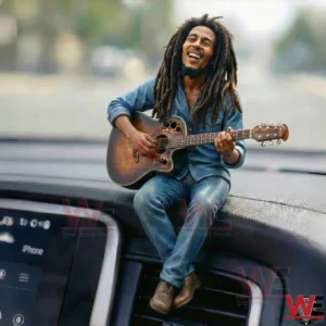 Resin figurine of a smiling musician with long hair playing guitar while sitting on a car dashboard!