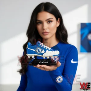 Woman holding a Chelsea brick football boot on a stand!