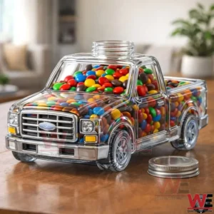 Clear pickup truck shaped jar filled with colorful candy on a wooden table!