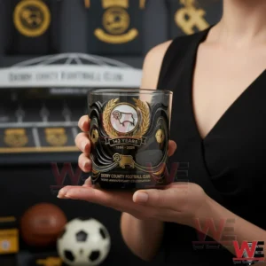 Hand holding Derby County Football Club 142 year anniversary whisky glass with black and gold design!