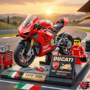 Red brick Ducati sport motorcycle display with rider figure tools and anniversary plaque on a racetrack!