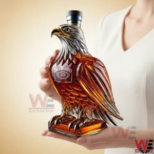 Eagle shaped whisky bottle held in hands against light background!