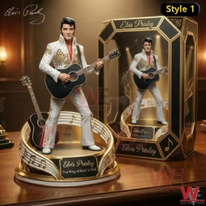 Elvis Presley memorial figure wearing a white stage suit and holding a guitar on a decorative base!