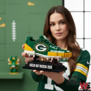 A person holding a green football themed shoe model made from building blocks!