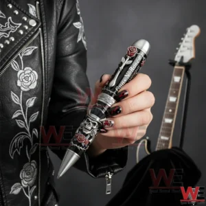 Guns N' Roses 40th Anniversary Limited Edition Pen 3 Hand holding a Guns N Roses anniversary metal pen with skull and rose design!