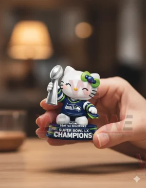 Hand holding a Seattle Seahawks themed cat ornament with trophy and champion base text!