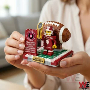 Hands holding Indiana Hoosiers brick football champion display with trophy and football backdrop!
