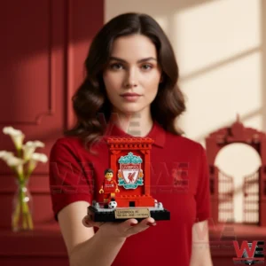 Woman holding a Liverpool FC anniversary building brick display!