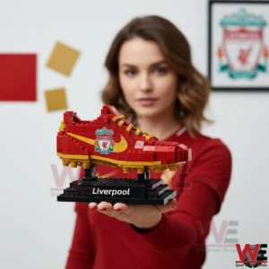 Woman holding a Liverpool brick football boot on a stand!
