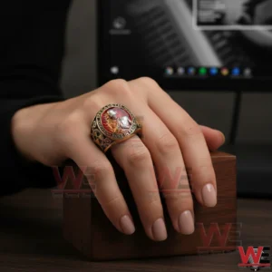 Megadeth Rust In Peace ring with red center worn on a hand.
