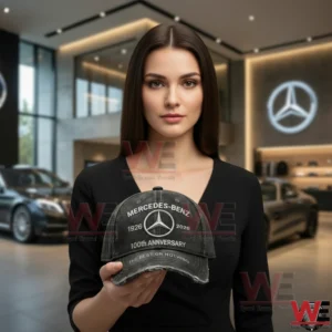 A woman holding a Mercedes Benz cap inside a luxury car showroom!