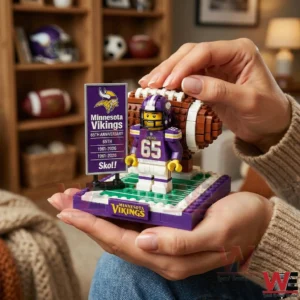 Hands holding a brick built Minnesota Vikings sixty five year anniversary football display in a living room.