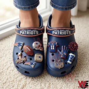 Person wearing New England Patriots themed clogs with football charms!
