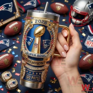 Hand holding New England Patriots Super Bowl Champions 2026 insulated tumbler with gold details and football themed background!