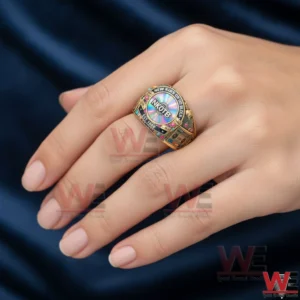 Gold NKOTB ring with colorful center stone worn on a hand!
