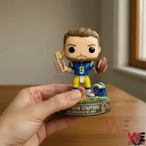 Hand holding Matthew Stafford Rams MVP collectible figure with trophy and football.