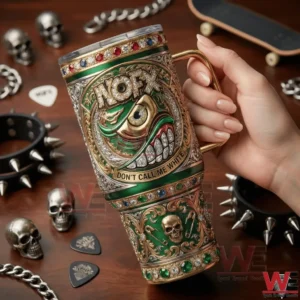 Hand holding an ornate green and gold NOFX tumbler with an eye emblem and punk themed details!