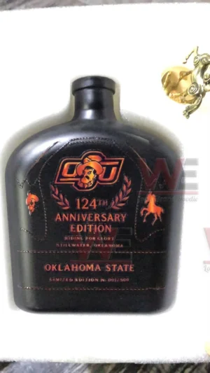 Black leather wrapped Oklahoma State commemorative bottle with embossed logo and orange details!
