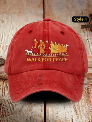 Red baseball cap with monks walking embroidery and Walk For Peace text!