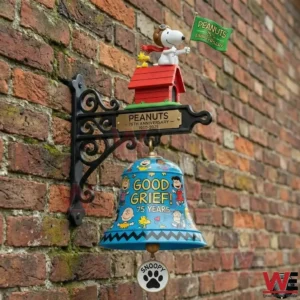 Peanuts anniversary wall bell on a brick wall with Snoopy and Woodstock on a red doghouse!