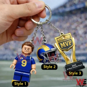Hand holding a football player keychain with helmet and trophy!