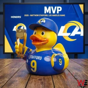 A rubber duck dressed as a football player holding a trophy on a wooden surface!