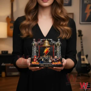 A person holding a small brick built rock concert stage with musicians and stage lights!