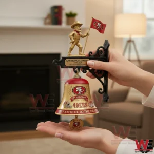 Hands holding a gold and red Forty Niners anniversary wall bell indoors!