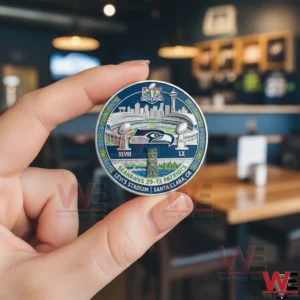 Hand holding Seattle Seahawks Super Bowl LX commemorative coin indoors!