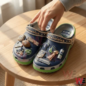 Seattle Seahawks themed clogs with championship charms on a wooden table!