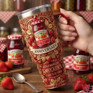 Hand holding a Smuckers anniversary tumbler in a rustic kitchen!