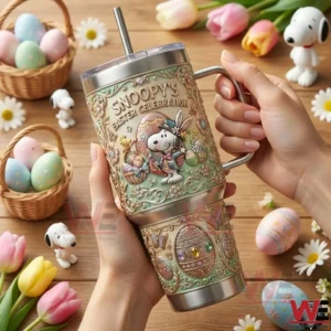 Hand holding a Snoopy Easter Celebration tumbler decorated with Easter eggs and spring flowers!