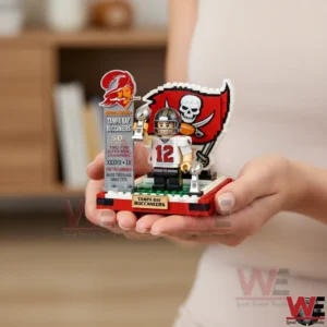 Hand holding a Tampa Bay Buccaneers brick player figure with Super Bowl trophy and team logo background!