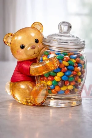 Golden teddy bear holding a glass jar filled with colorful candies!