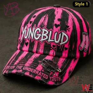 Pink and black Yungblud baseball cap with embroidered logo on dark background.