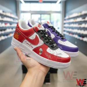 Hand holding a red and white custom Nike Air Force 1 with a purple themed pair behind it inside a sneaker store!