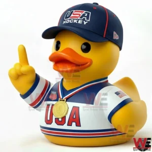 Yellow duck wearing a USA hockey cap and jersey with a gold medal raising one finger!