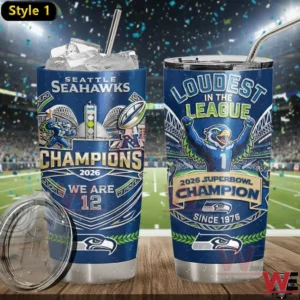 Two Seattle Seahawks Champions 2026 tumblers on a wooden table in a stadium.