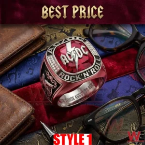 Large silver AC DC ring with a red gemstone on colorful musical themed fabrics with glasses and a wallet!