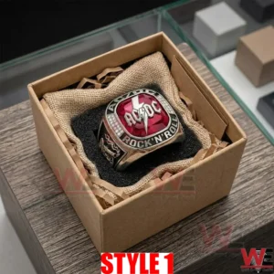 Custom AC DC silver ring with red stone presented in a brown cardboard box on burlap and foam padding!