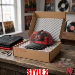 An open box with foam holding the red and black AC DC cap in a studio!