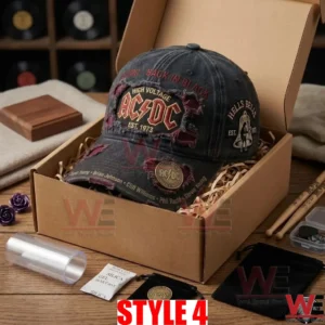 An open cardboard box containing the black AC DC cap surrounded by unboxing items!