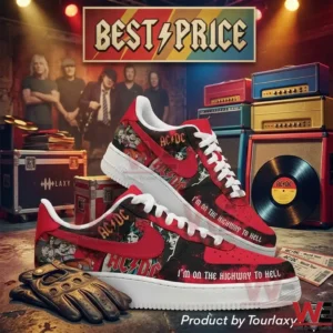 A pair of custom AC DC sneakers on a concrete floor surrounded by rock music equipment like amplifiers and records!