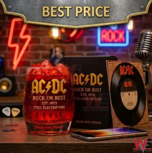 AC DC Rock Or Bust themed glass with red liquid and ice next to a branded box and vinyl record on a wooden desk with neon lights!