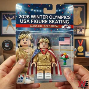 Packaged USA figure skating mini figure in gold outfit with medal USA flag cape small flag and bouquet!