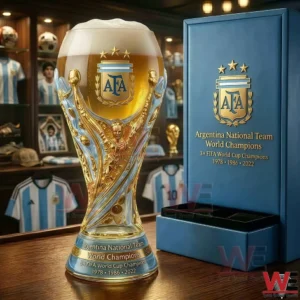 Trophy style beer glass with AFA crest next to a blue Argentina champions display box on a table!