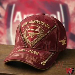 Arsenal FC 140 Years Anniversary Classic Cap 5 Red Arsenal anniversary cap on a wooden table with a blurred Arsenal background!
