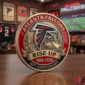 Atlanta Falcons 60th anniversary coin with Falcons logo Rise Up and 1966 to 2026 in a sports memorabilia room.
