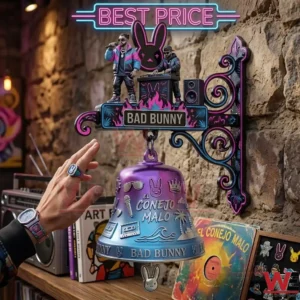 A hand reaching for a purple and blue decorative bell mounted on a stone wall.